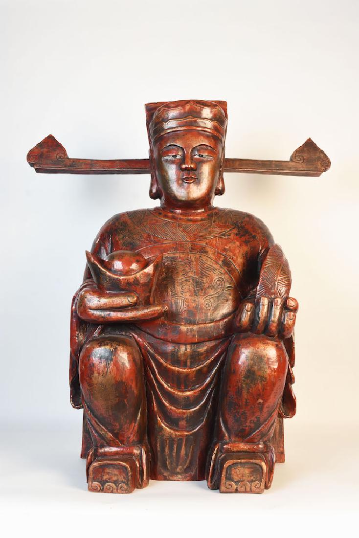 Large Wood Carved Buddha Statue: Large wood carved Buddha in a seated position. This impressive Buddha has a red and gold hue with great amount of detail. It measures 32" x 18 1/2" x 15 1/2". It is in good condition however it does h