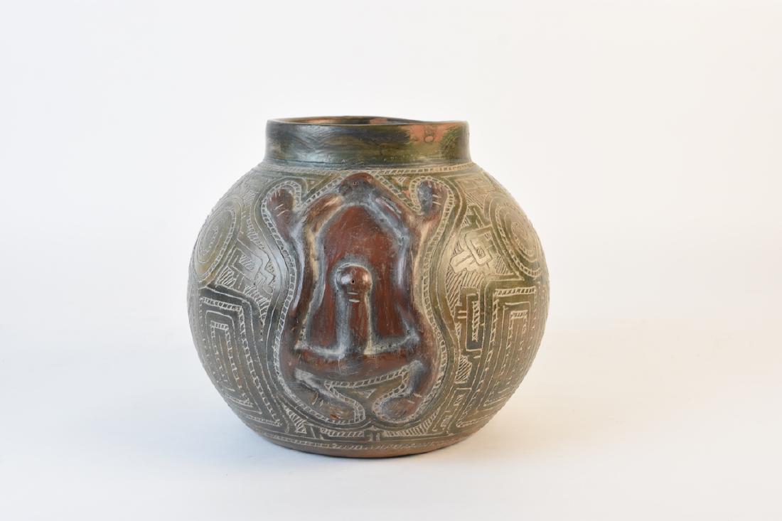Hand Carved Clay Vessel: Clay vessel with highly detailed design throughout the body. It stands 8 1/2" tall with an opening of 5 1/2". It is in good condition. Contact our recommended 3rd party "for profit" shipper Pak Mail a