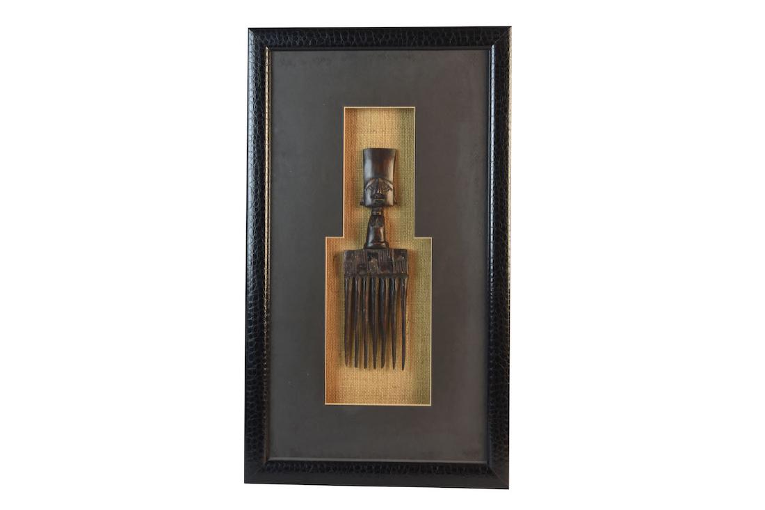 Chokwe Tribal Hair Comb: Chokwe tribal hair comb presented in a textured shadow box frame. It is in very good condition. The frame measures 26 1/4" x 15 1/4" while the comb is 13" long. Contact our recommended 3rd party "for 