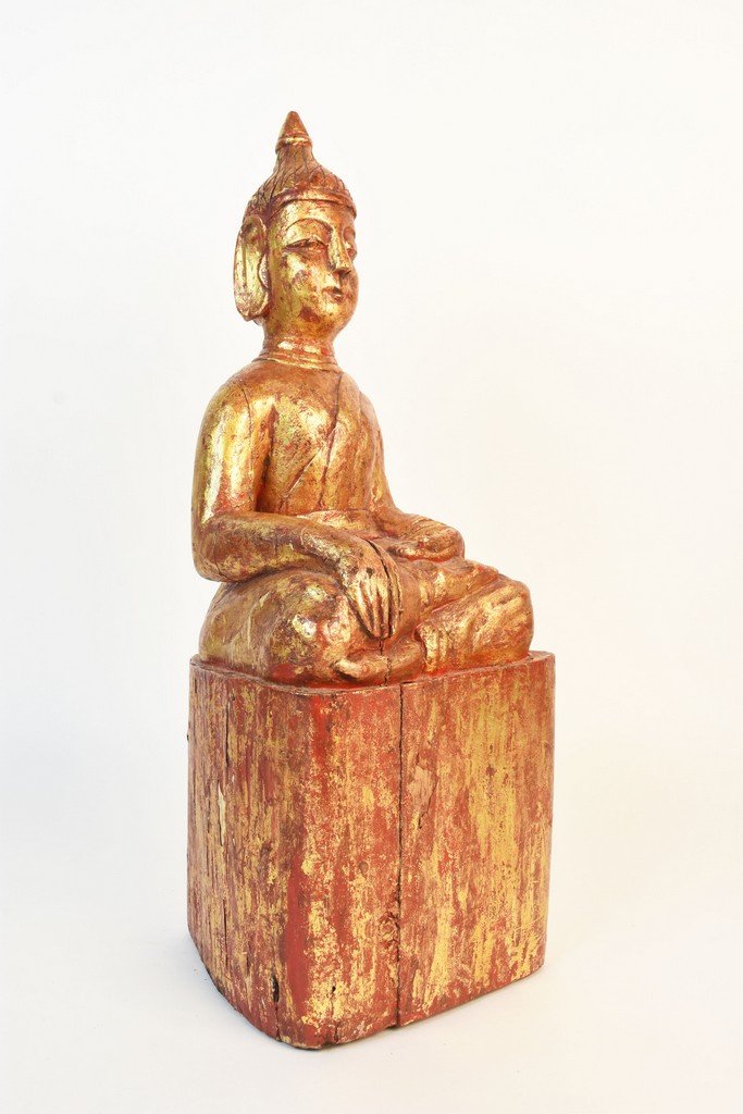 Wood Carved Sitting Buddha Statue: Wood carved sitting buddha statue in red with a gold overlay. This state is in good condition and stands 19 1/2" tall. Contact our recommended 3rd party "for profit" shipper Pak Mail at (260) 637-4809