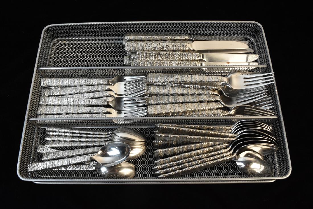 Michael Aram's Gotham Flatware Set: Stunning set of designer Michael Aram flatware set from the Gotham collection including (10) salad forks, (11) dinner forks, (9) teaspoons, (10) dinner spoons and (11) knives measuring 9". This flatwa