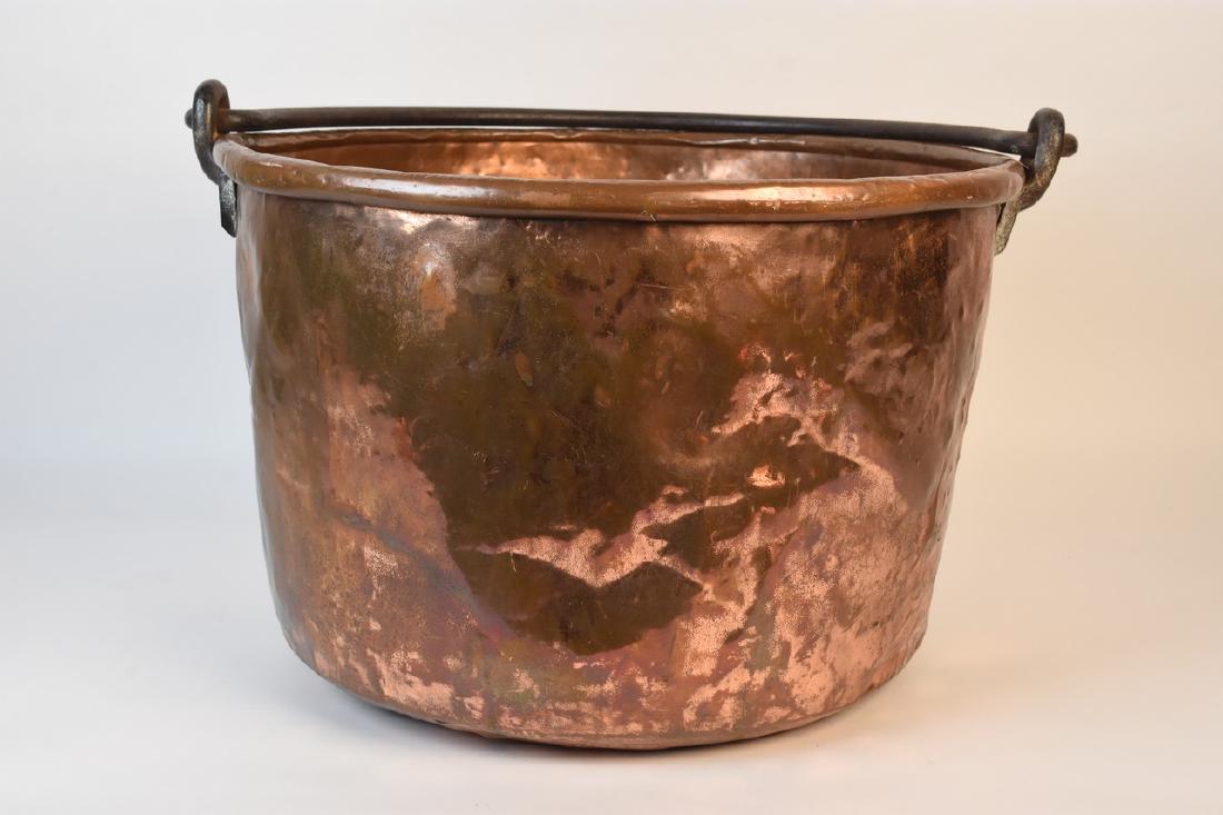 Copper Kettle With Metal Handle: Copper apple butter kettle with wrought iron swing handle. This old kettle has a great aged patina with several imperfections for a perfect aged look. It measures 22" in diameter x 14 1/2" tall. Fire 