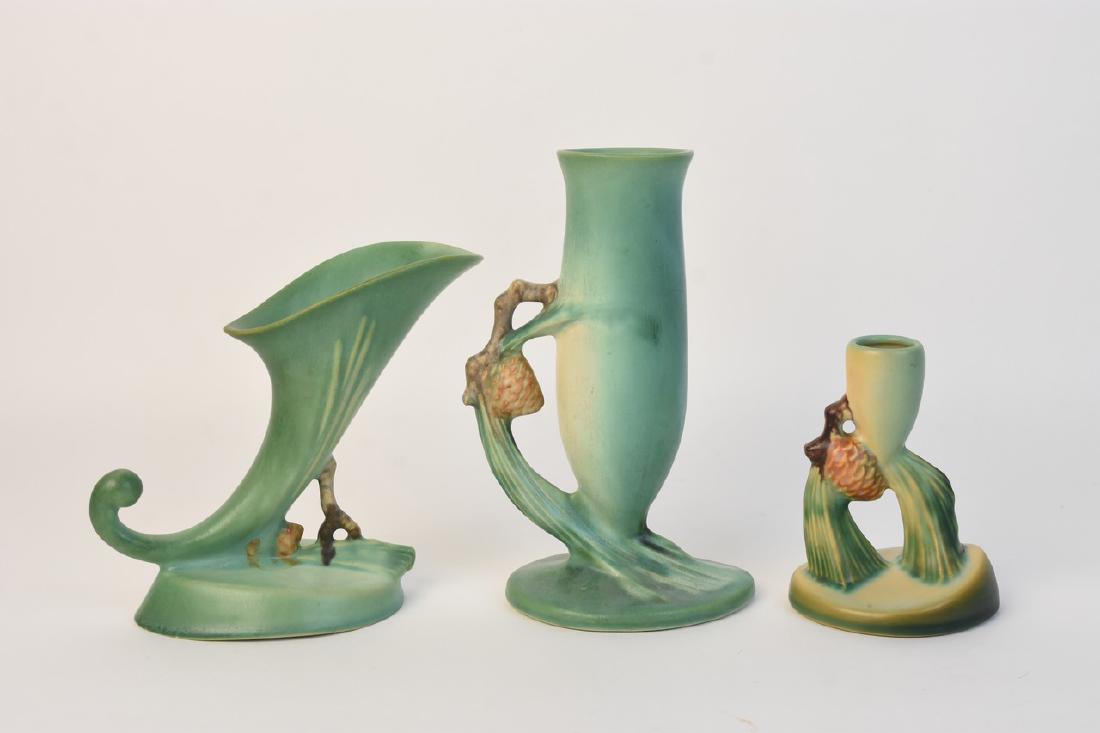 Roseville Pottery "Pine Cone" 112-7 & 451-4: A collection of three Roseville Pottery pieces in the mint green "Pine Cone" style. The pieces include a cornucopia vase (marked very lightly to underside); a candlestick holder marked "Roseville U.S.