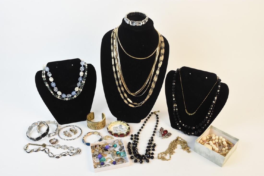Costume Jewelry Including Steinmetz, Monet, and Nr: An assortment of costume jewelry a Metropolitan Museum of Art cuff; a Monet gold tone chain necklace; a Steinmetz “SFJ” beetle brooch; a variety of faux stone pieces in a Von Maur box; a pair of M