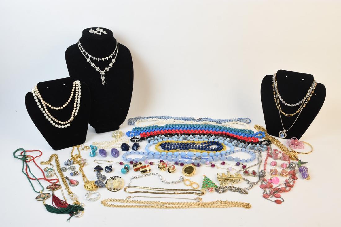 Costume Jewelry Including Trifari and Monet: An assortment of costume jewelry including necklaces, bracelets, brooches and clip-on earrings. Notable a Laguna iridescent necklace with clip-on earrings set; Monet gold tone clip-on earrings; Napier