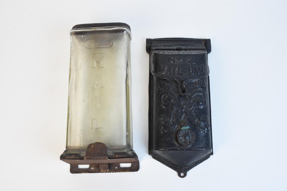 Antique Mailboxes Including Griswold: A pair of antique mailboxes. The pair includes one comprised of glass and metal marked "Visible Mail" in embossed lettering; and one cast iron "Standard No. 2" mailbox by Griswold. Items show heavy ru