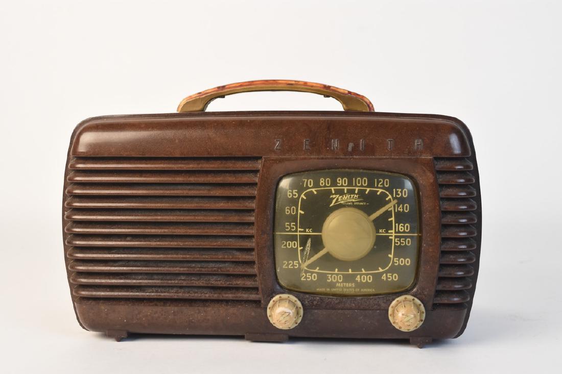 Zenith 6D510 Bakelite Radio, c. 1940s: A Zenith model 6D510 AM long distance radio with a bakelite casing dating to the 1940s. Condition details include large crack to front; a few surface markings and scuffs; sticker residue; and discolor