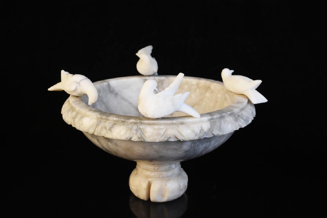 Alabaster and Marble Birdbath Centerpiece: A tabletop birdbath comprised of marble and alabaster. The birdbath includes four removable birds and rests on a turned base. No visible maker's mark. Condition details include residue to its interior