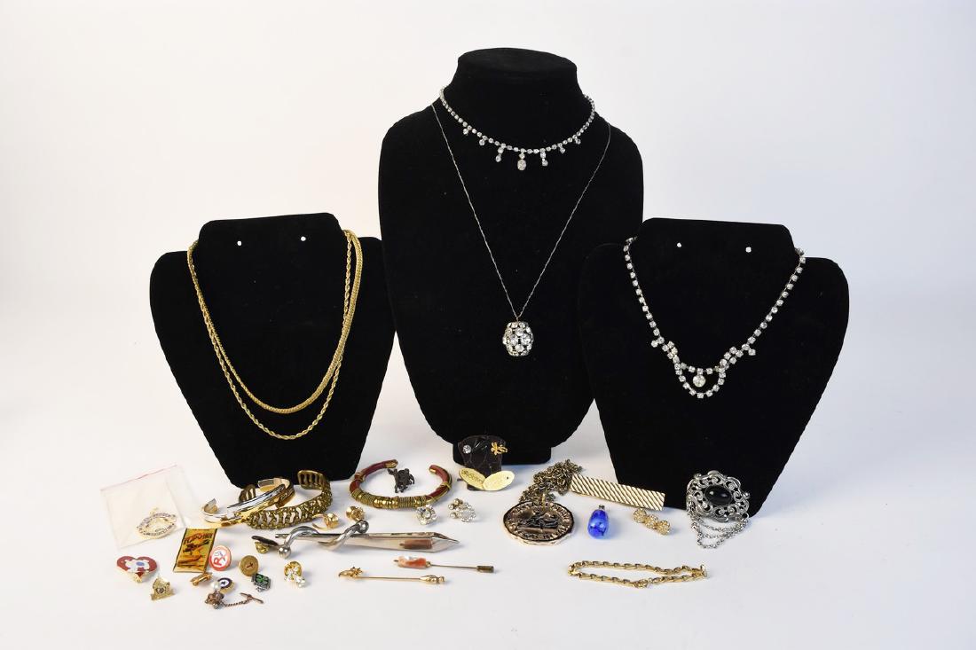 Assorted Costume Jewelry Including Avon: An assortment of costume jewelry including a Grand Masonic Lodge pin; a Caesars' Palace Las Vegas medallion; an 18K gold plated necklace; hat pins; 4H pins; rhinestone necklaces; cuff bracelets; a blu