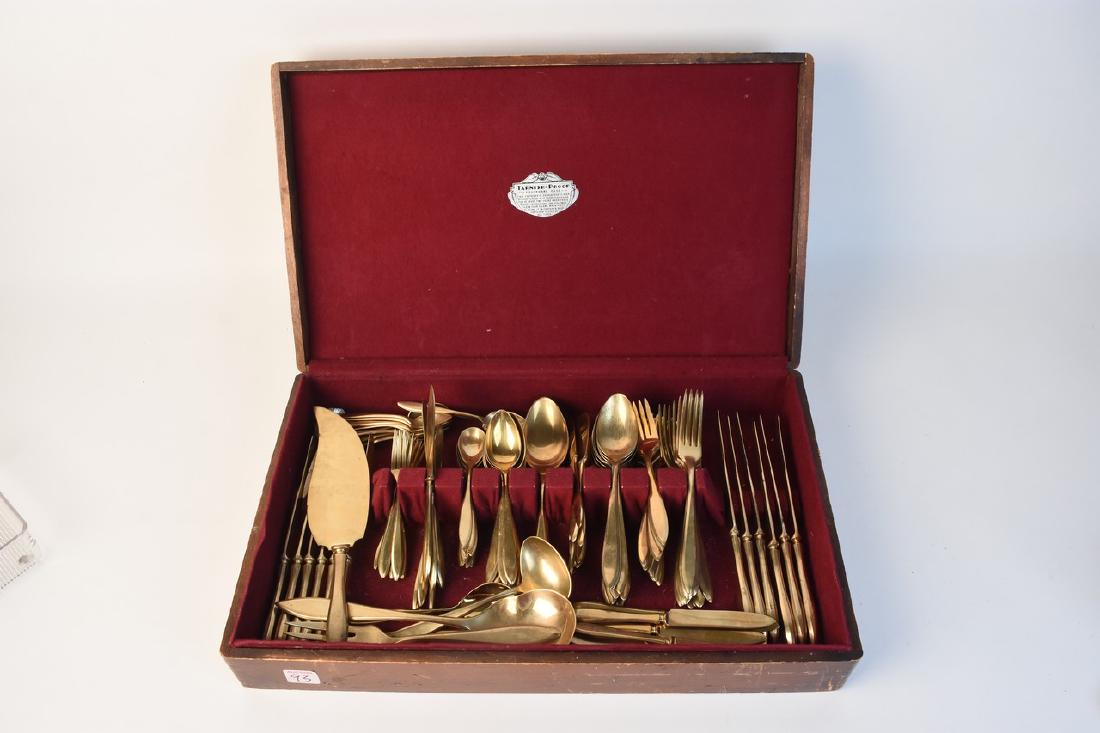 129 Piece Regal Dirigold Flatware Set: 129 piece Regal Dirilyte Dirigold flatware set in a tarnish-proof wood case. This unique gold toned flatware set was made between 1937-1986 and is now retired. This set is in good used condition with 