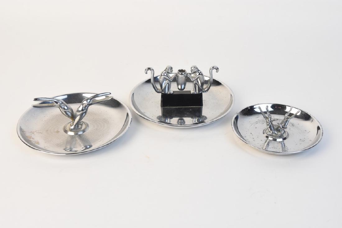 Pincherette & Hamilton Figural Ashtrays: (2) Hamilton products chrome ashtrays. One features a pair of toucans and the other a pair of monkeys holding a jar. We also have a Pincherette ashtray featuring a pair of alligators. These characters