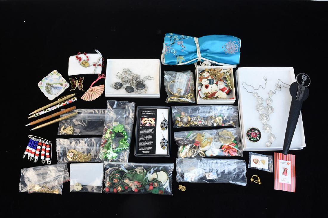 Costume Jewelry Including Timex Ladie's Watch: An assortment of costume jewelry featuring a pair of gold tone ladie's watching include Timex and Pulsar. Also included are Christmas themed brooches; a Japanese themed fabric organizer; a rosary; a g