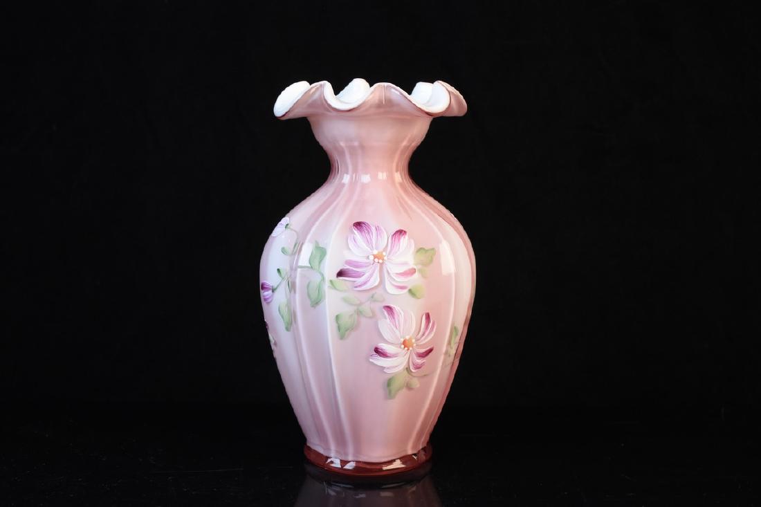 Signed Fenton Hand Decorated Art Glass Vase: A signed Fenton art glass vase with hand painted decorations of flowers. The piece is pink and signed in silver tone ink by Julia Powell. Measures approximately 7.5" tall. Light surface markings and l