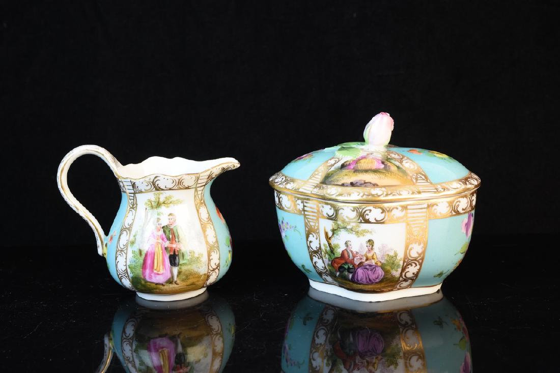 Antique Carl Thieme Potschappel Porcelain: A pair of porcelain items by Carl Thieme of Potschappel. The items include a creamer and a lidded dish adorned with a rose pull. The items are marked with a hallmark used between circa 1888 and 1901. 
