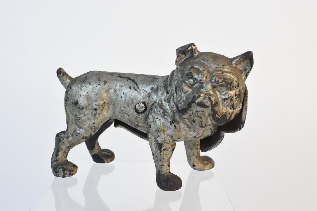 Cast Iron Bulldog Doorstop (Hubley?), 1920s: A cast iron doorstop possibly produced by Hubley in the 1920s. It includes one screw which may be a modern replacement. Heavy damage including unaligned position; rust and loss of finish; dusty; surfa