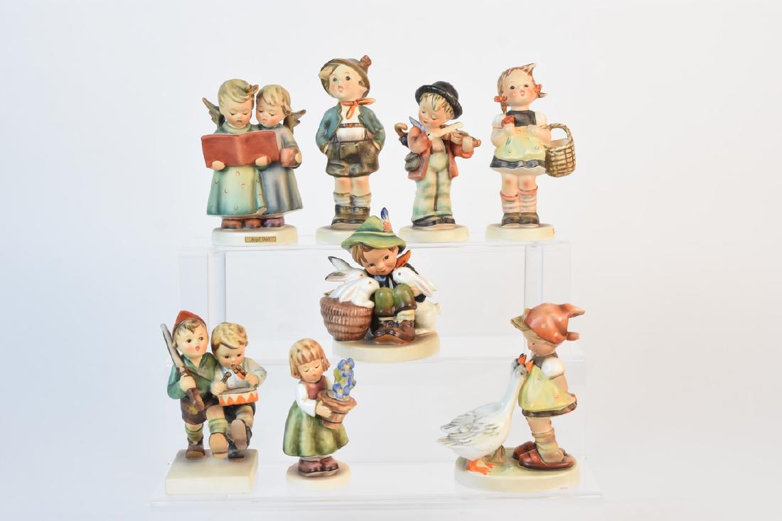Eight Vintage Hummel Figurines: A lot of eight vintage Goebel Hummel figurines including #50 "Volunteers" TM3; #98 "Sister" TM3; #341 "Birthday Present" TM7; #58 "Playmates" TM3; #4 "Little Fiddler" TM3; #95 "Brother" TM3; #261 "Ang