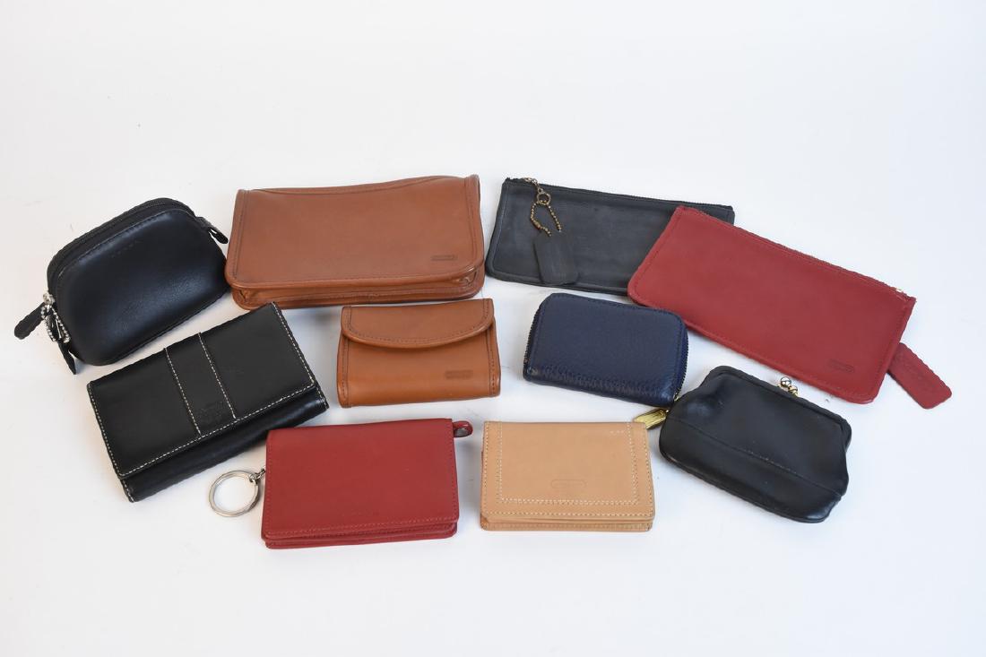 Coach Accessories Including Wallets: An assortment of ten Coach accessories. Items include pouches, wallets, change purses, and a pocket book. Light wear to leather; light surface markings. The brown pouch measures 4.75" H x 7.75" W x 1.