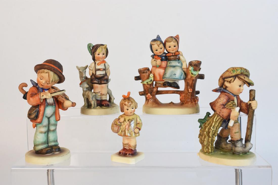 Hummel Figurines Incl. TMK-4 Goat Herder: A selection of Goebel Hummel figurines. Includes TMK-5 “On Secret Path“; TMK-4 “Goat Herder“; M.I. Hummel Club TMK-7 “I Brought You a Gift“; TMK-5 “Coquettes“; and TMK-5 “Little Fidd