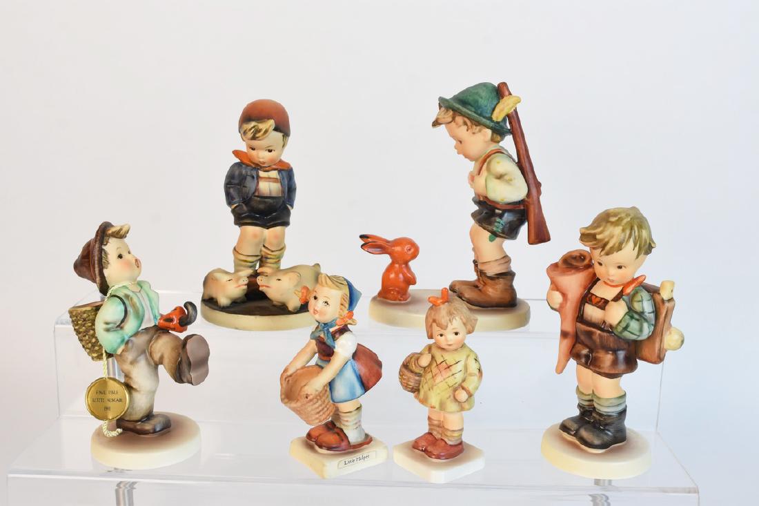 Hummel Figurines Incl. TMK-3 Farm Boy: A selection of Goebel Hummel figurines. Includes TMK-3 "Farm Boy"; TMK-6 "Little Scholar"; TMK-6 "Sensitive Hunter"; TMK-7 Final Issue "Globe Trotter"; TMK-5 "Little Helper"; and Collector's Club TMK-