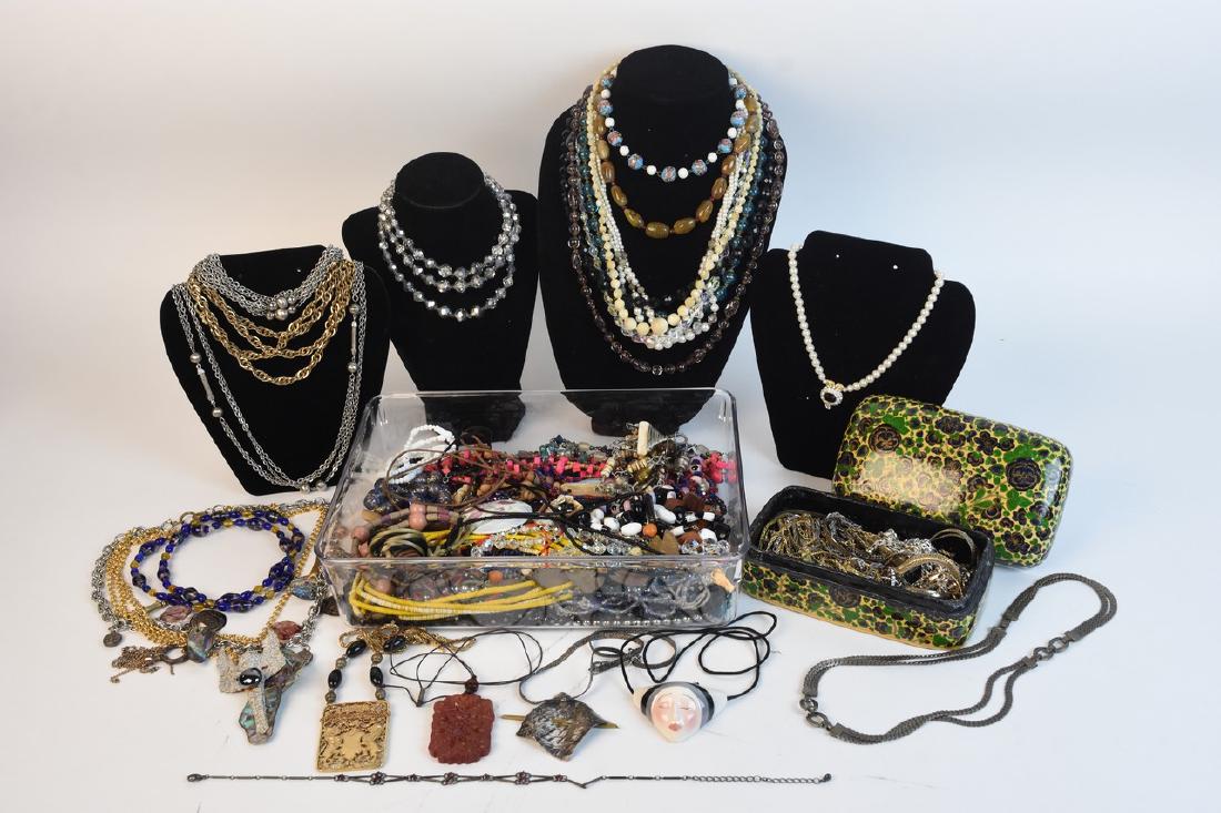 Assorted Costume Jewelry Incl. Sterling: An assortment of costume jewelry including sterling silver. Items include necklaces and bracelets with many of them being hand crafted. Silver tone and gold tone chains are presented in a wooden trink