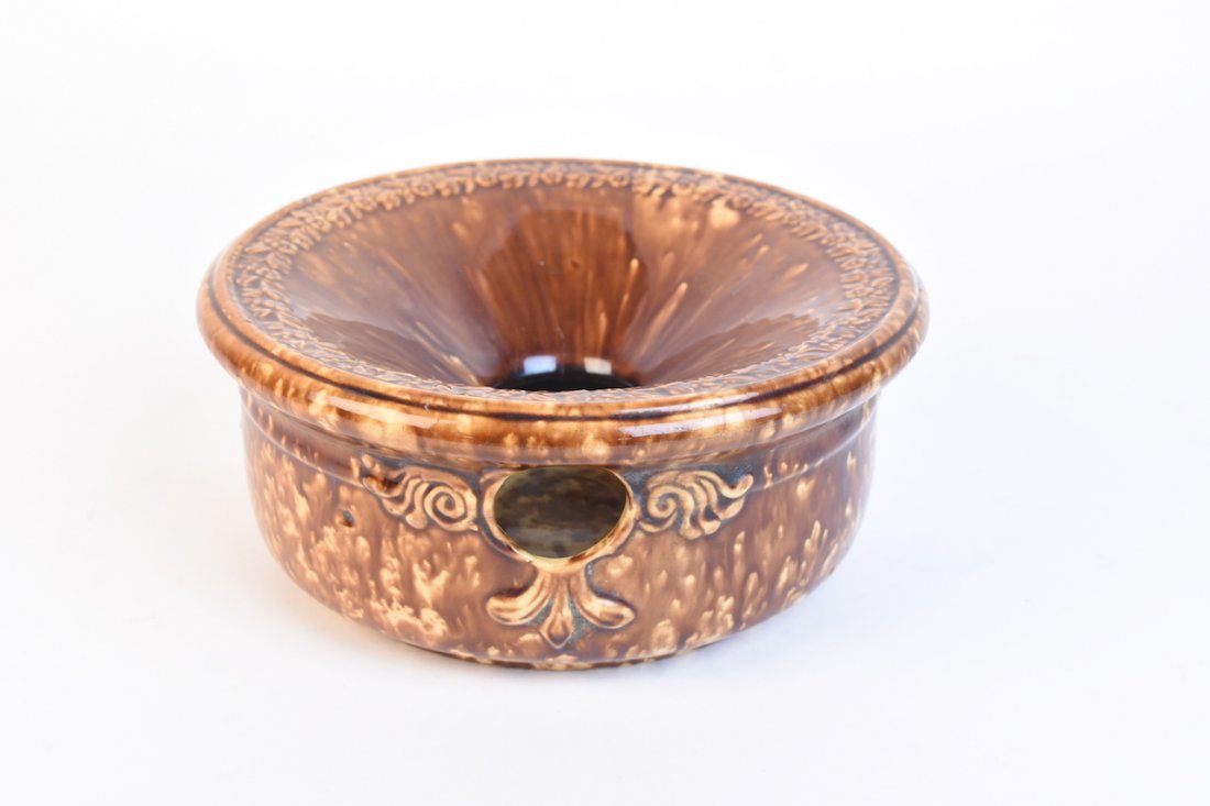 Bennington Pottery Style Spittoon: A yellowware pottery spittoon in the style of Bennington with a Rockingham brown mottled glaze. It measures approximately 4" H x 8.25" W. Minor surface markings; interior residue and stains. Contact o