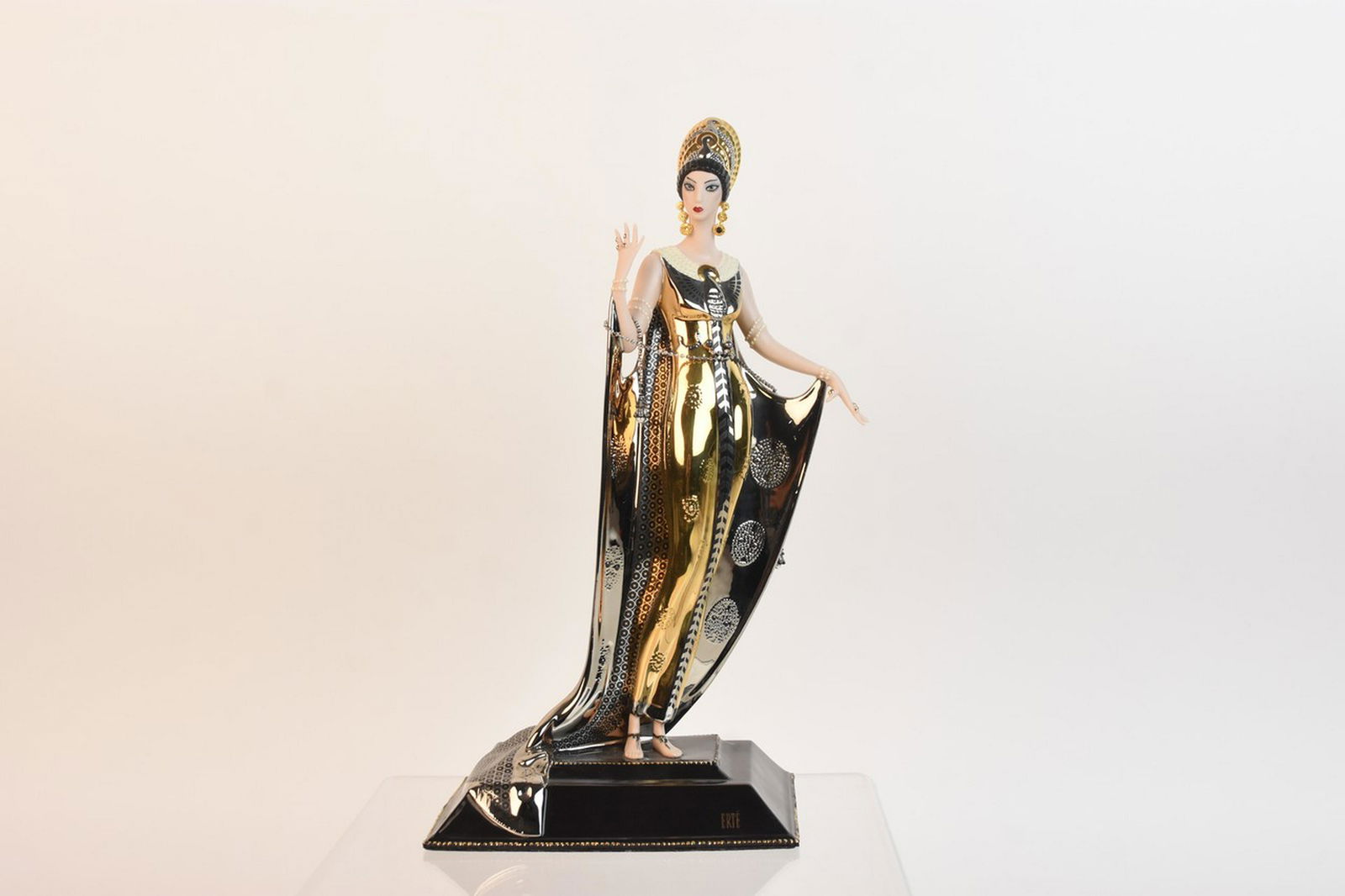House of Erte "Isis" Porcelain Figurine: A fine porcelain figurine titled "Isis" depicting the Egyptian Goddess. Marked to its underside "House of Erte, Isis, Limited Edition, No. A5133." The figurine features a vibrant gilt finish and inclu