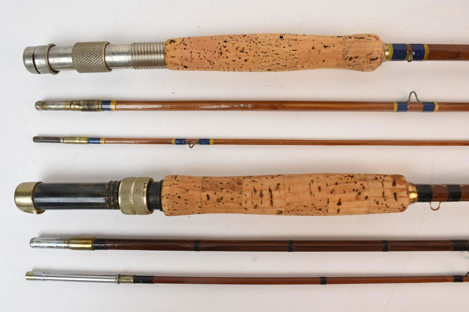 (6) Vintage Bamboo and Split Cane Fly Rods: An assortment of six collapsible vintage fly fishing casting rods comprised of bamboo and split cane. 2-piece to 3-piece with cork & stacked rattan handles. Moderate wear- surface scratches and chips;