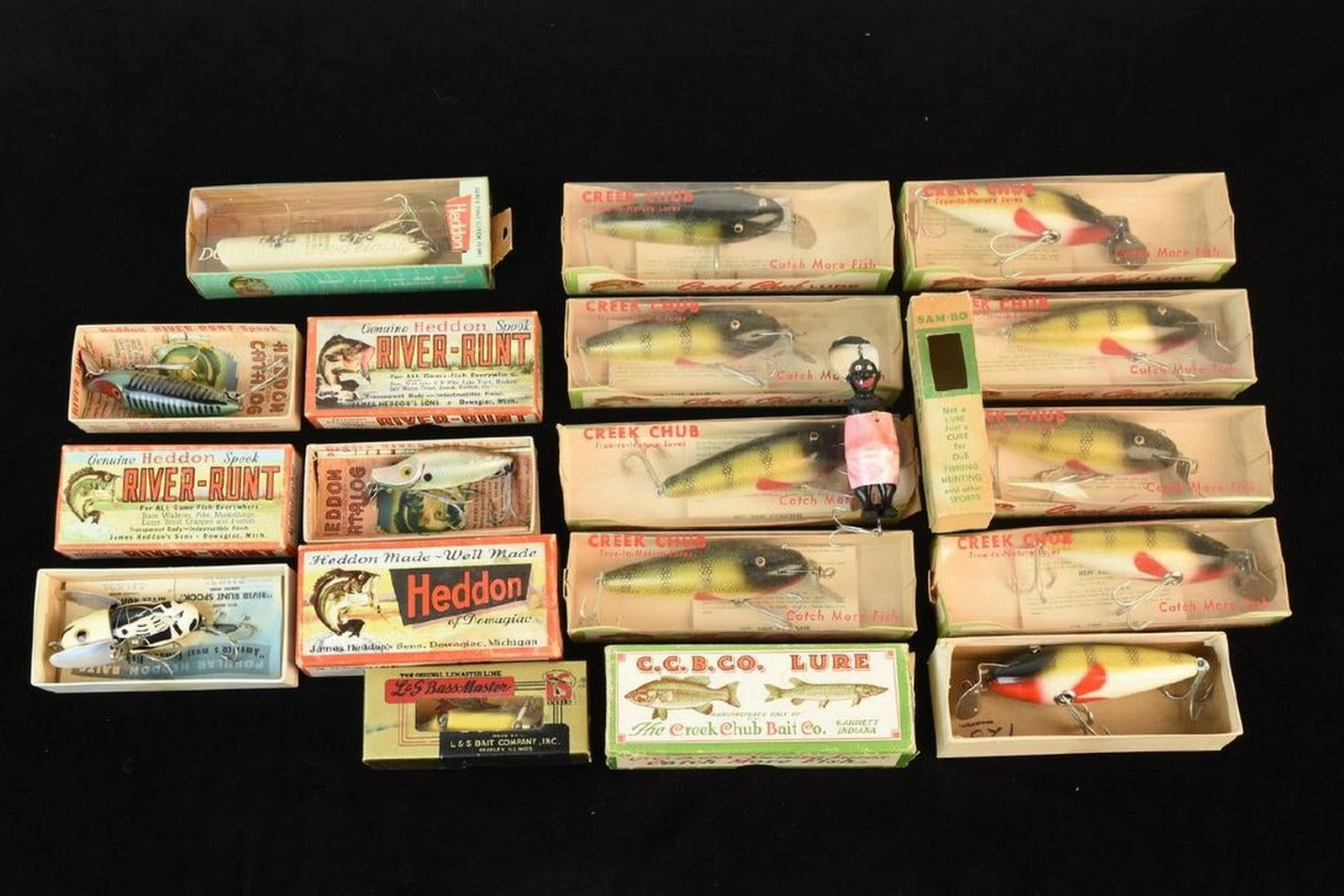 Vintage Fishing Lures Including "Sambo the Gloom ": A collection of fifteen vintage fishing lures. Brands include Creek Chub Lure, Heddon, L&S Bass-Master, and one called “Sam-Bo the Gloom Killer” Contact our recommended 3rd party "for profit" ship