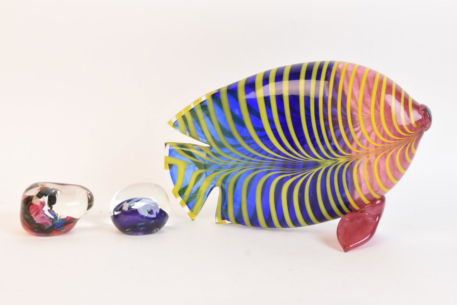Art Glass Incl. Figural Fish Signed by K. Nurminen: A selection of art glass pieces including a colorful figural fish designed by Kerttu Nurminen signed "K. Nurminen Nuutajärvi." Also included are two decorative paperweights. One is signed "Tom Bloyd.