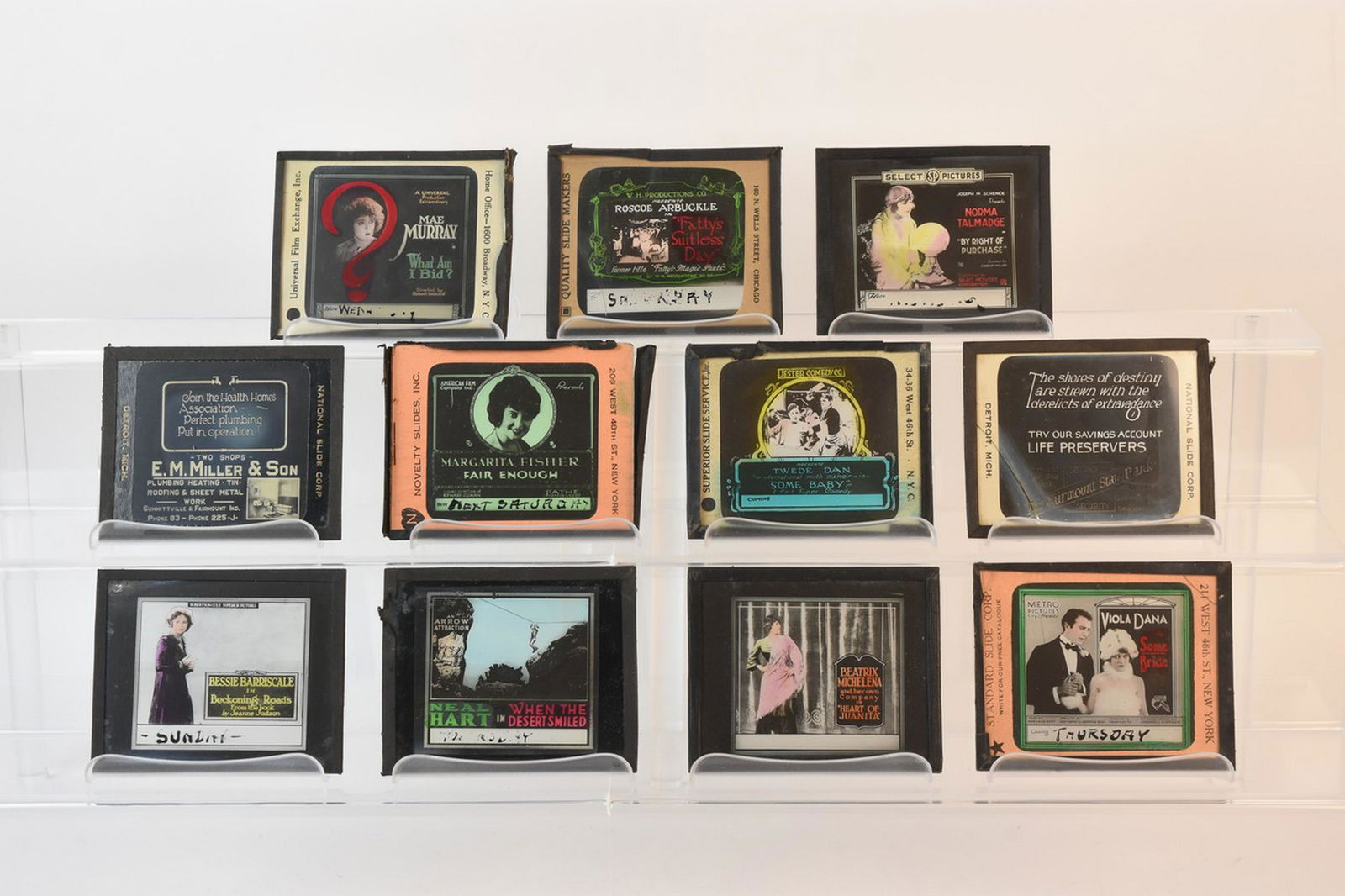 (11) Magic Lantern Glass Advertising Slide: A collection of glass advertising slides from the silent film era. The slides feature stars such as Norma Talmadge, Bessie Barriscale, Viola Dana, Neal Hart, Margaret Fisher, Twede Dan, Roscoe Arbuckl