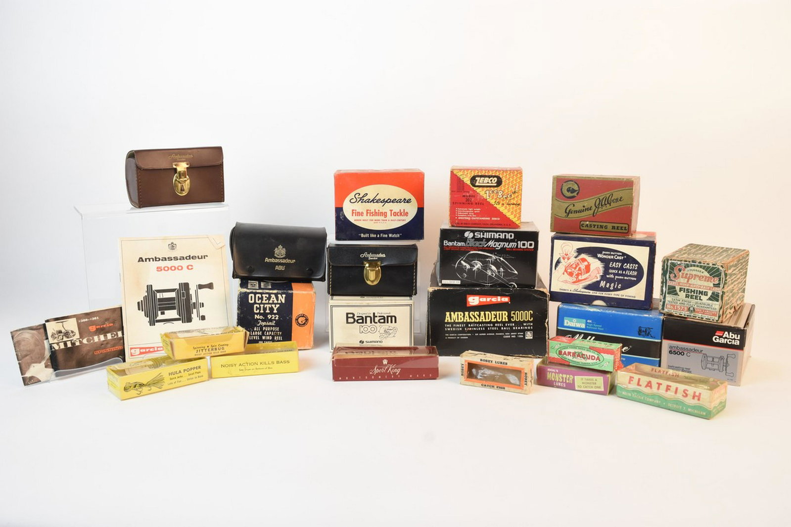 Vintage Fishing Reel & Lure Boxes: Assortment of fishing reel and lure boxes. Shakespeare 1766, Shakespeare 1810, Shimano Bantam Black Magnum 100, Daiwa Millionaire, Abu Garcia Ambassadeur 6500C, Zebco 202, Ocean City 922, Pflueger Sup