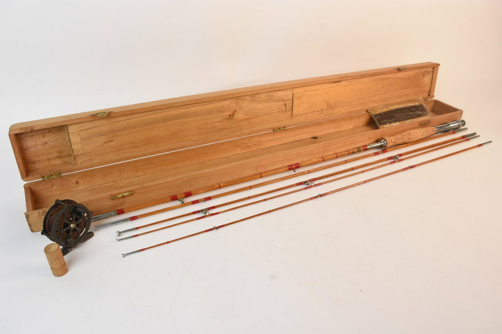 Vtg. Grampus Kiraku & Co. Bamboo Split Rod w/ Acc.: A Grampus Kiraku & Co. Japanese bamboo split rod in two pieces with three tips. Includes a cork handle. Presented in a wood box with a hidden storage compartment that includes lures, line, and more. A