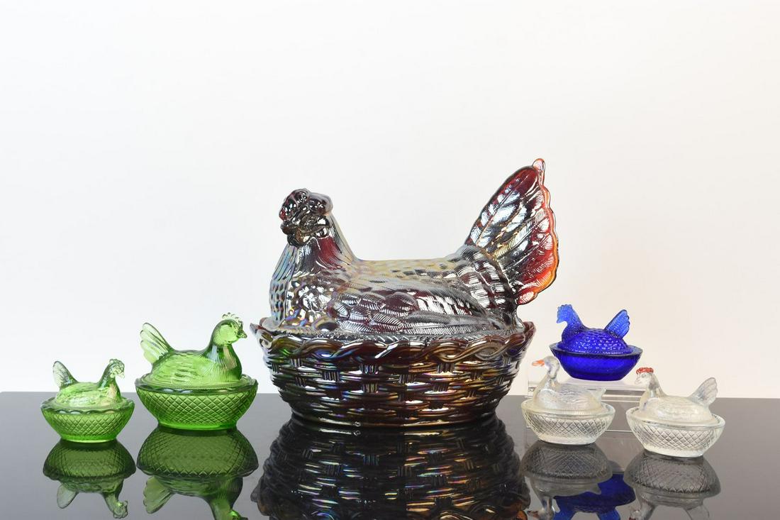 Glass Hen on Nest Dishes: An assortment of six glass nesting hen and duck dishes in various sizes. Includes carnival glass and pressed glass in clear, cobalt blue, and green. Light surface markings. No discernible maker's mark