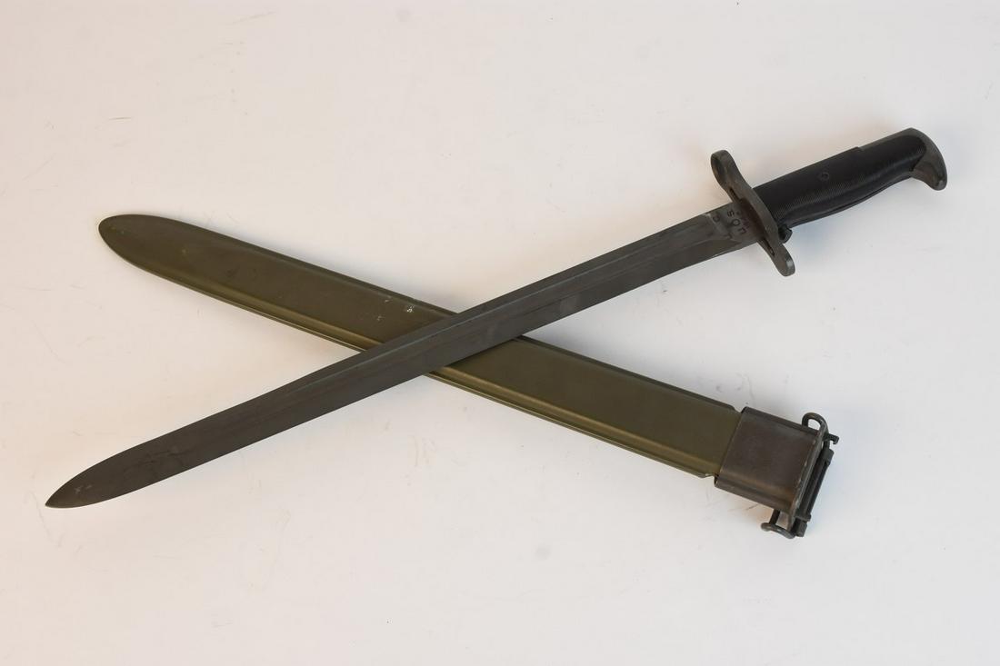 US WWII Era Garand Rifle Bayonet, c. 1942: A US issued WWII era Garand Rifle Bayonet. Marked "U. C. U. O. S. 1942" to its blade. Sheath is marked "U.S." Light surface scratches, scuffs, and areas of discoloration. Light wear to blade. Measures