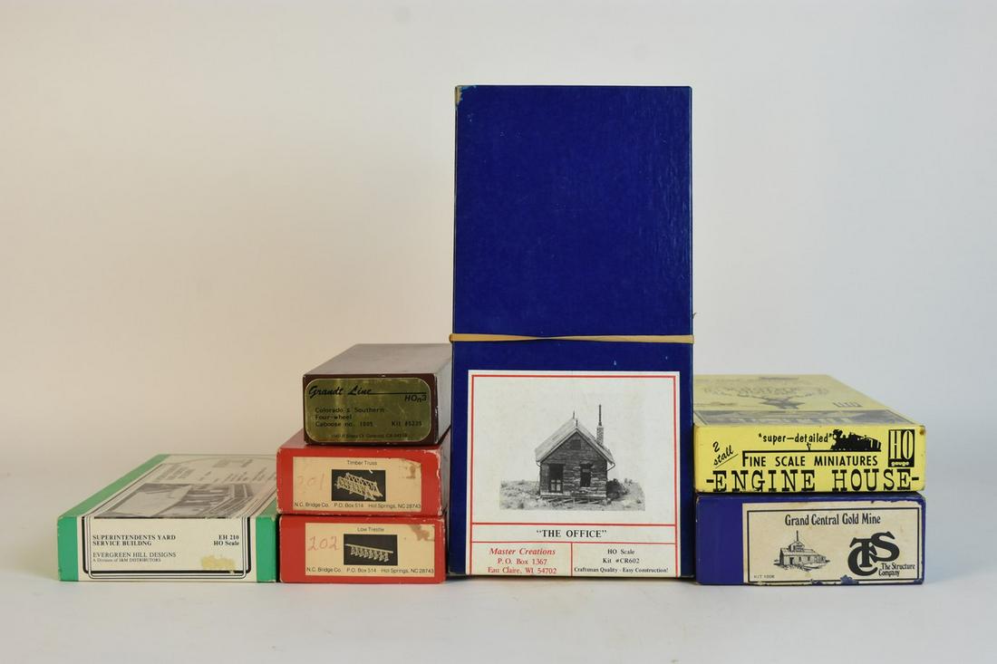 HO Scale Train & Building Model Kits: A set of seven HO scale train and railroad scenery/building model kits. Includes a Grandt Line HOn3 Colorado & Southern #1005 Caboose (5235); a Master Creations "Office" (CR602); two NC Bridge kits; a