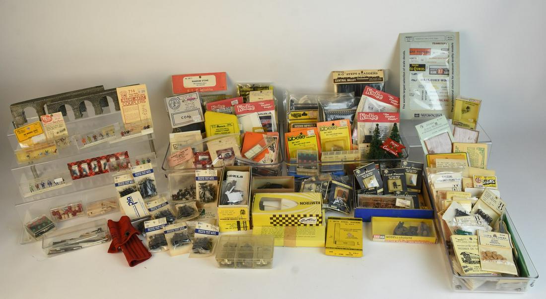 Large Assortment of Train Accessories/Scenery: A large assortment of various model railroad train accessories, scenery and parts. Includes model kits; Crowd Pleasers figures; decals; steps & ladders; bags of coal; track section clips; couplers; sw