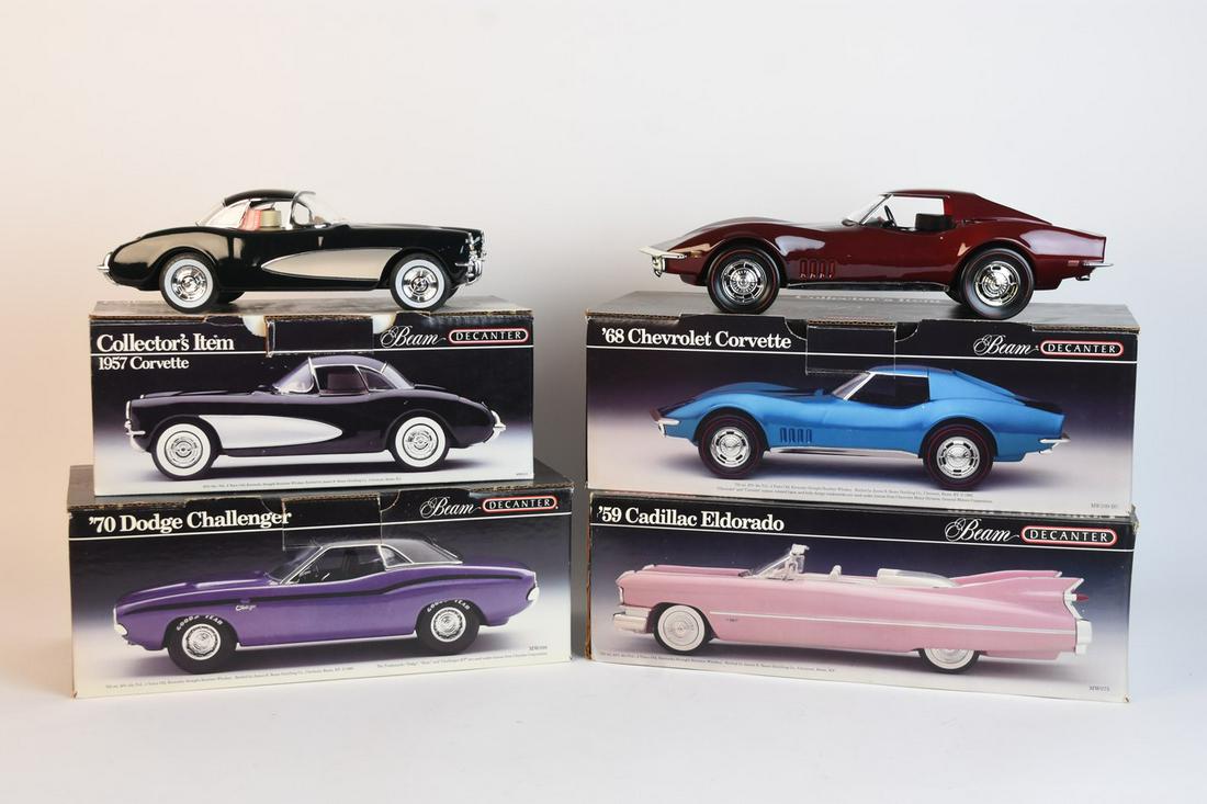 Four Jim Beam Automotive Decanters: A set of four Jim Beam automotive themed decanters with original packaging. Includes '59 Cadillac Eldorado '68 Chevrolet Corvette; '70 Dodge Challenger; and 1957 Corvette. Edge and corner wear to boxe