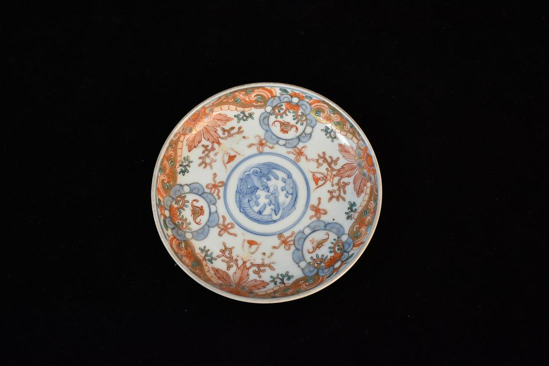 Antique Japanese Imari Ware Saucer: An antique Japanese porcelain Imari Ware saucer. It features intricate detail in cobalt blue and gilt and red enamel. Some fading and loss of color; light surface scratches. Measures approx. 5.5" in d