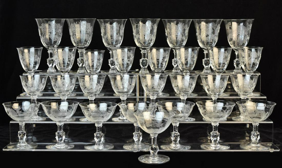 (31) Heisey Crystal "Rose" Stemware: A selection of thirty-one pieces of Heisey crystal in the "Rose" pattern featuring finely etched floral detail throughout their bowls. Includes (8) low sherbet glasses; (8) cordial glasses; (7) wine g