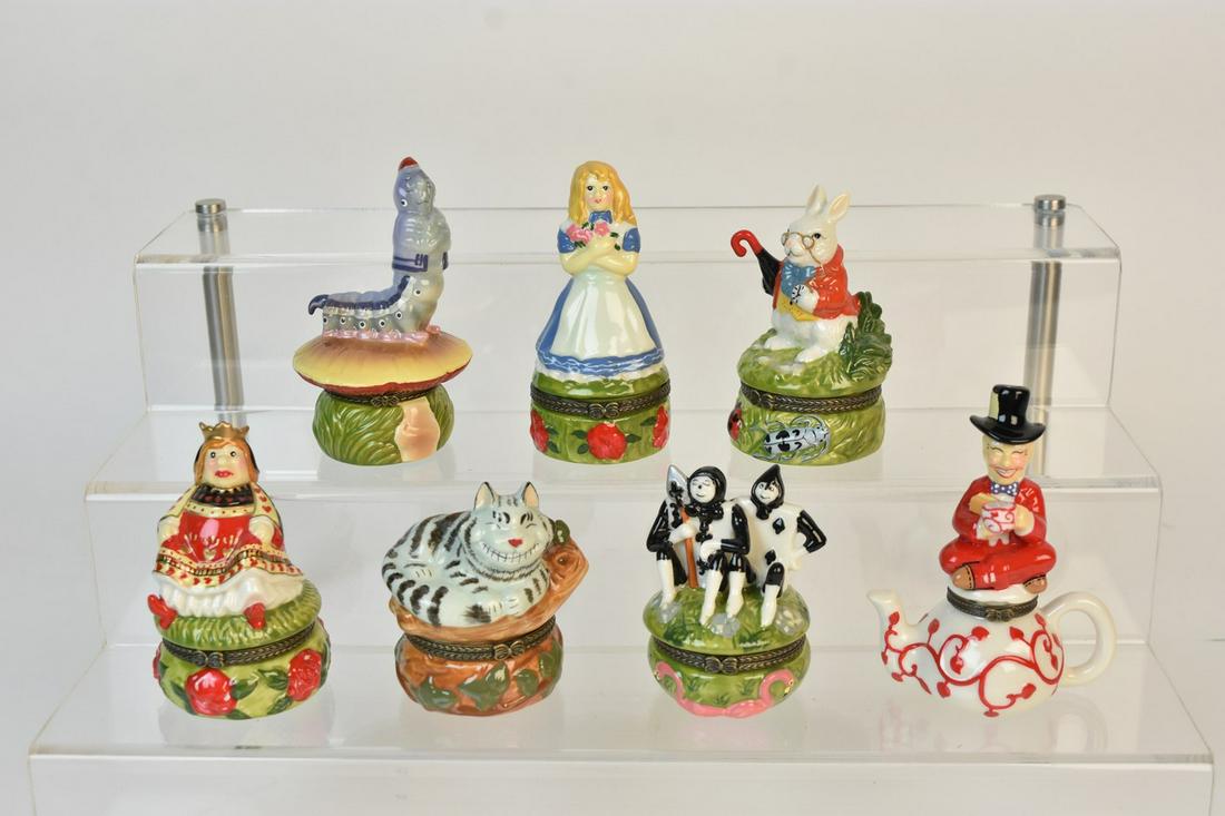 Alice in Wonderland Trinket Boxes: A selection of seven Alice in Wonderland pill boxes/trinket boxes in the Limoges style with hand painted detail. They include The Mad Hatter, Queen of Hearts, The White Rabbit, The Caterpillar, Alice,