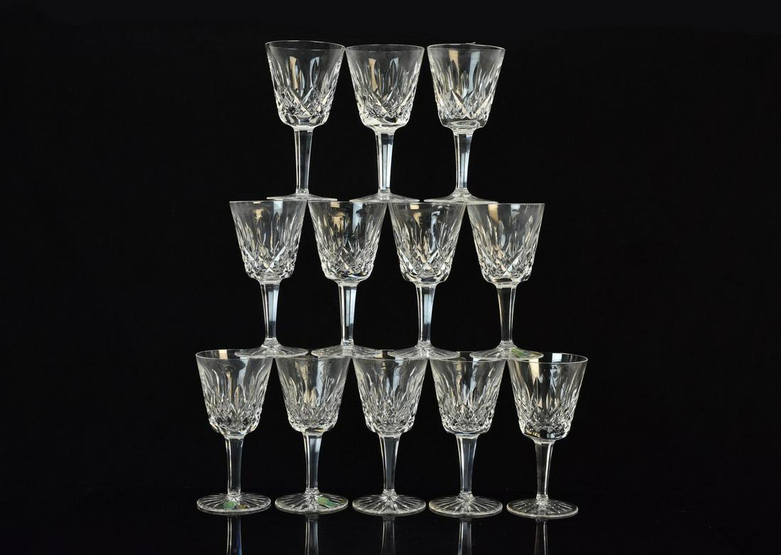 (12) Waterford "Lismore" Claret Wine Glasses: A selection of twelve Waterford Crystal Claret Wine glasses in the "Lismore" pattern measuring approx. 6" H. Would benefit from cleaning; very minor surface imperfections & factory imperfections. Plea