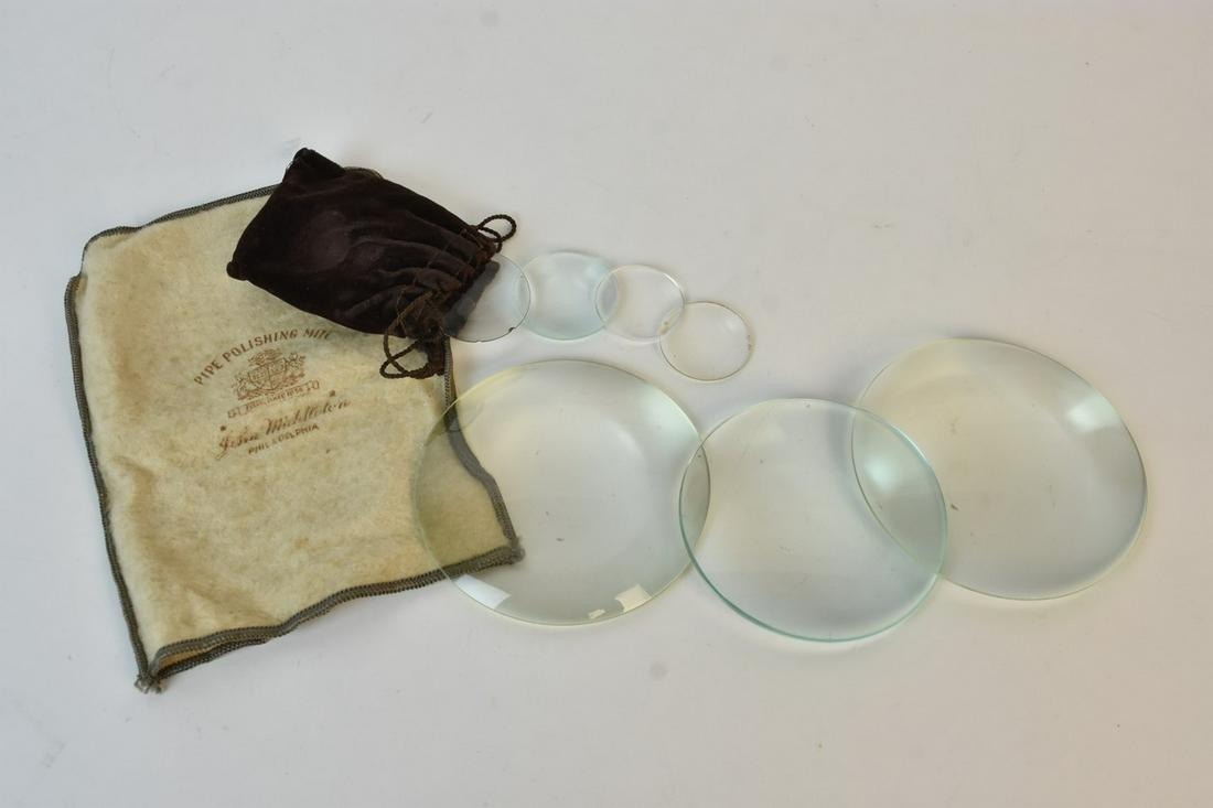 (7) Convex Glass Magnifying Lenses: A selection of seven glass convex lenses in various sizes. One is marked "Sun-Ray France."; some are plano convex lenses. Light surface residue. Largest measures 4 1/2" W. Medium measures 1 3/4" W. Sm