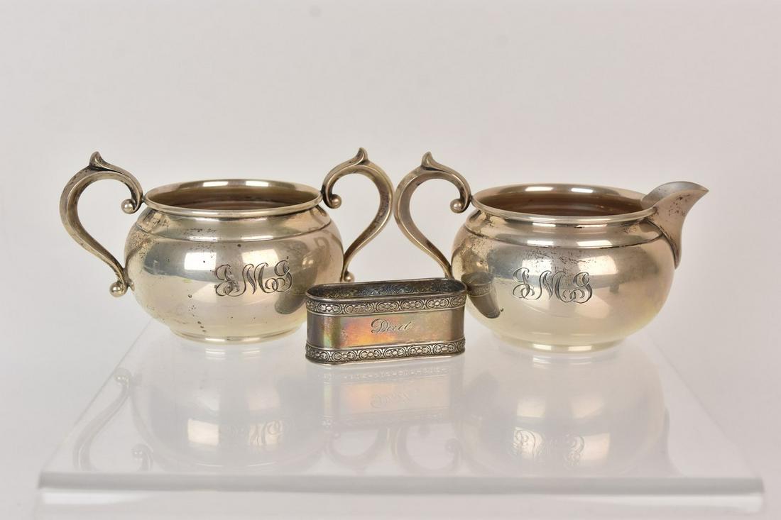 Sterling Silver Incl. Gorham, 6.05 ozt: A trio of sterling silver including a 909-910 Gorham creamer and sugar. Also included is a napkin ring. Largest piece measures approx. 3" H x 5" W; total approx. weight is 6.05 ozt. Please Note: Schee