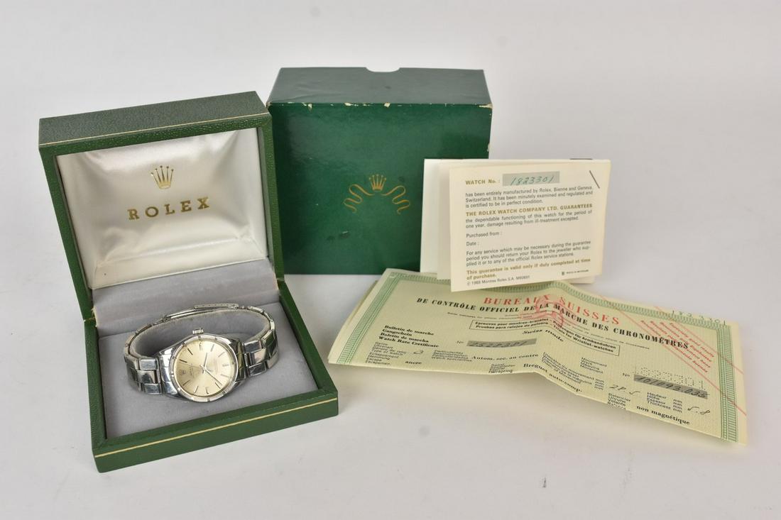1960s Gentleman's Rolex Oyster Perpetual Watch: A circa 1969 gentleman's Rolex "Oyster Perpetual" Superlative Chronometer wristwatch comprised of stainless steel. Watch no. 1823301; movement diameter 28.5 mm. Includes original owner's booklet, COA,