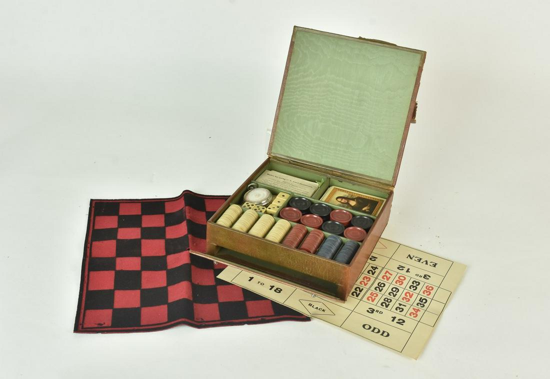 Vintage Game Set w/ Celluloid Dice: A vintage game set featuring poker chips, celluloid dice, Monte Carlo spinner, red & black checkers, cards, and instructions. Presented in a storage case with heavy wear; discoloration to chips & dice