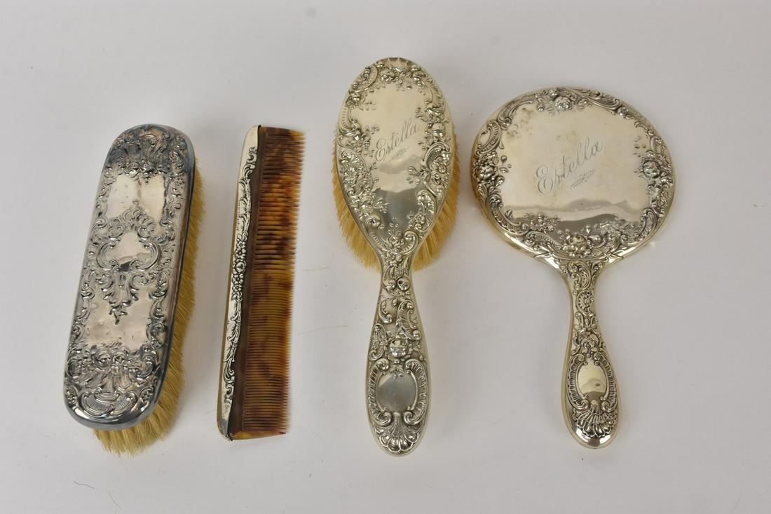 Sterling Silver Vanity Set: A sterling silver vanity set, pieces marked "Sterling" to underside or sides, There is no sterling marking on the hair brush. This set Includes four pieces, including a hand mirror measuring 16" long.