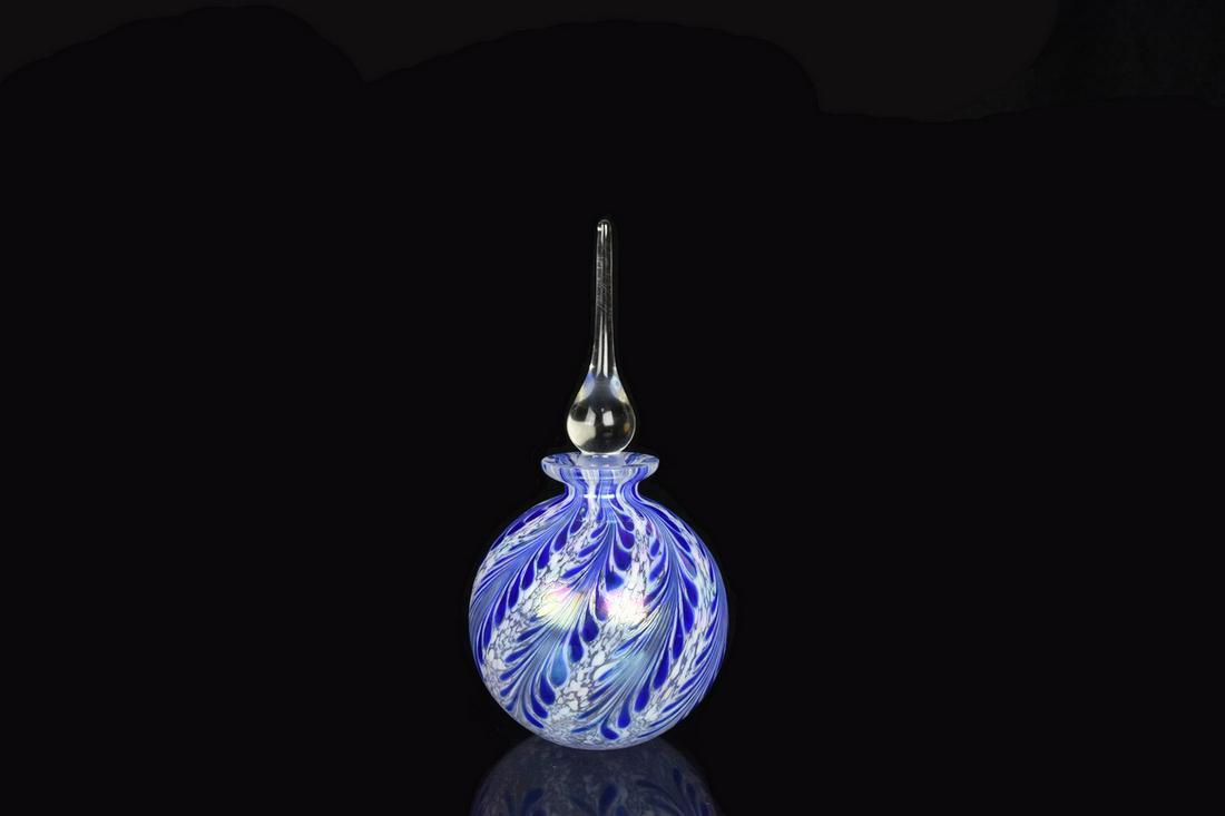 Blue Art Glass Perfume Bottle: A blue and white art glass perfume bottle with stopper. It features a swirl pattern throughout. Unmarked. Measures approx. 6" H. Please Note: Scheerer McCulloch Auctioneer only ships a limited number