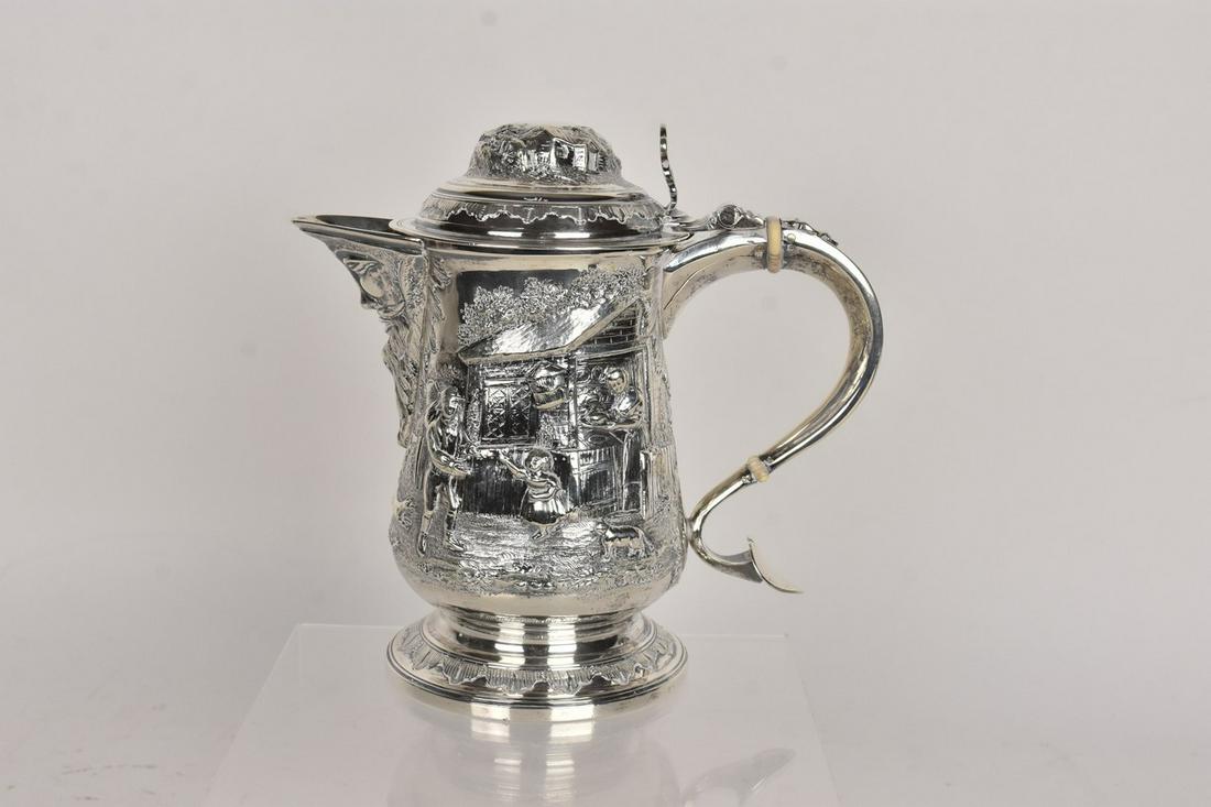 18th Century Georgian Pitcher: A George III water pitcher/beer jug comprised of sterling silver weighing approx. 31.50 ozt inclusive of all materials. Hallmarked to its underside "S. H." likely for Solomon Hougham. Also hallmarked 