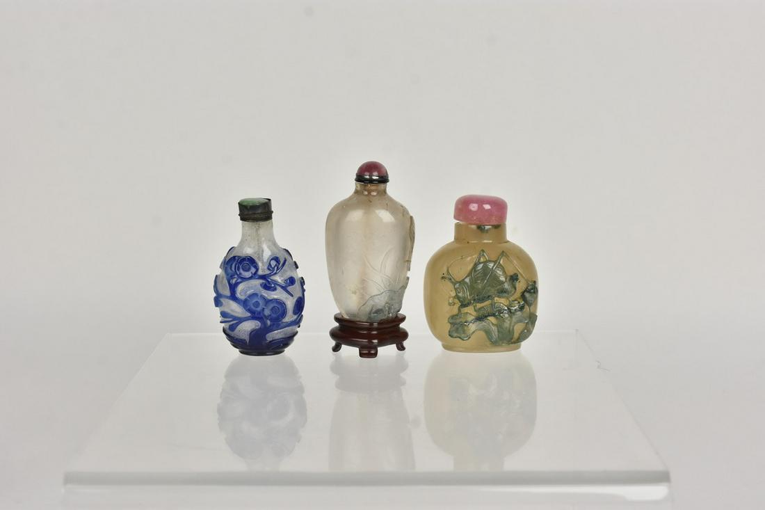 (3) 18th-19th Century Carved Overlay Snuff Bottles: 1) 2.5" x 2" x 1.25" , top with spoon 1" x .5" x 2" This large white Peking glass with jade colored overlay is intricately carved and in wonderfull condition. Complete with round, pink stone top with
