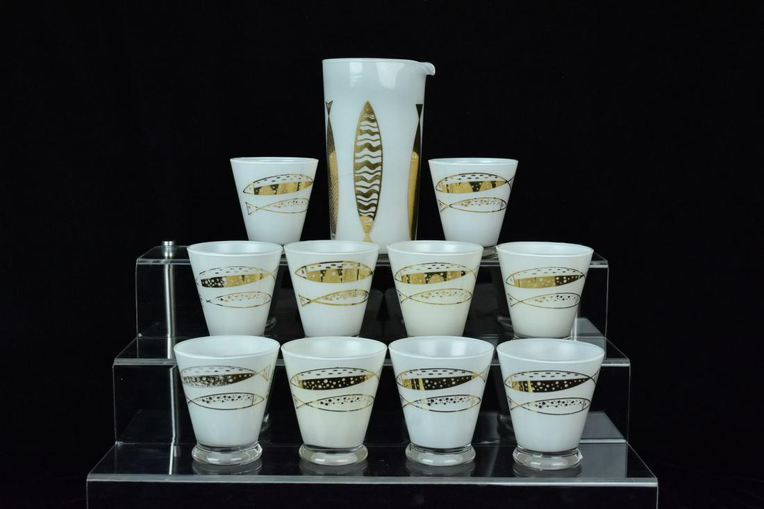 Fred Press White Cased Gold Fish Rocks Glasses & Pourer: 11 piece mid-century bar set. Includes 10 rocks glasses, each holds 7 1/2 oz and measures 3 1/4" H. Also included is a pitcher/ pourer. Maker embossed bottoms. Please Note: Scheerer McCulloch Auctione